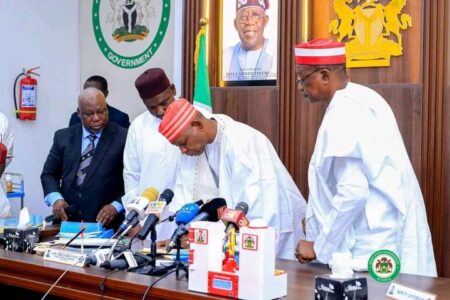 Gov Yusuf while signing the bills into law