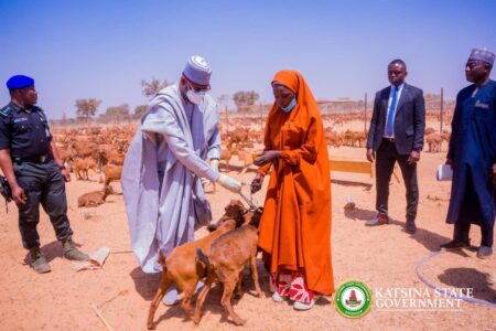 Handing over the goats to a beneficiary