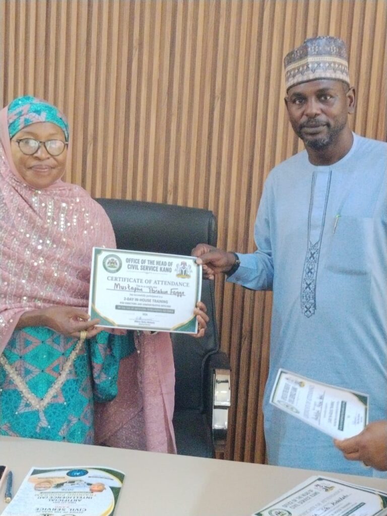 Kano State Head of Service presented a certificate of attendance to (DAGS), KANGIS, Mustapha Ibrahim Fagge